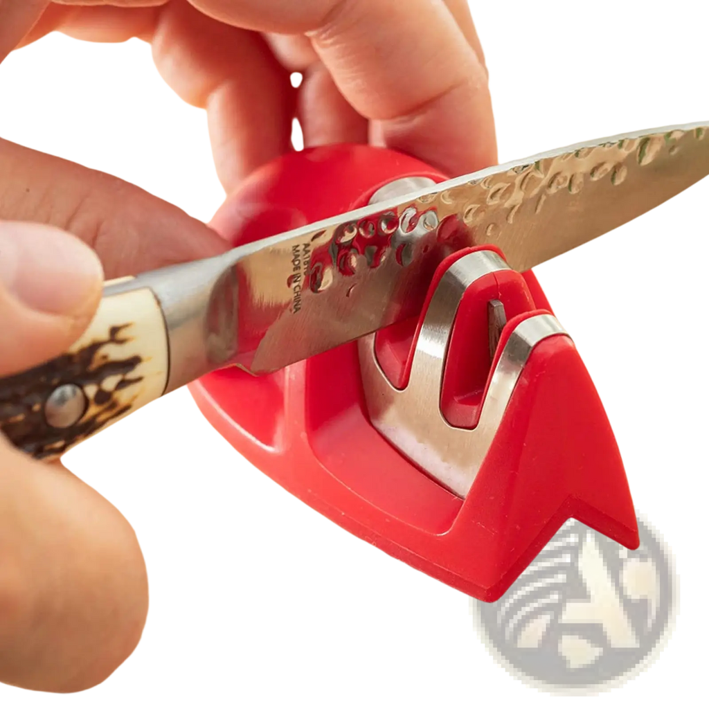 Red plastic and stainless steel portable 3 slot mouse knife sharpener with textured blade being sharpened