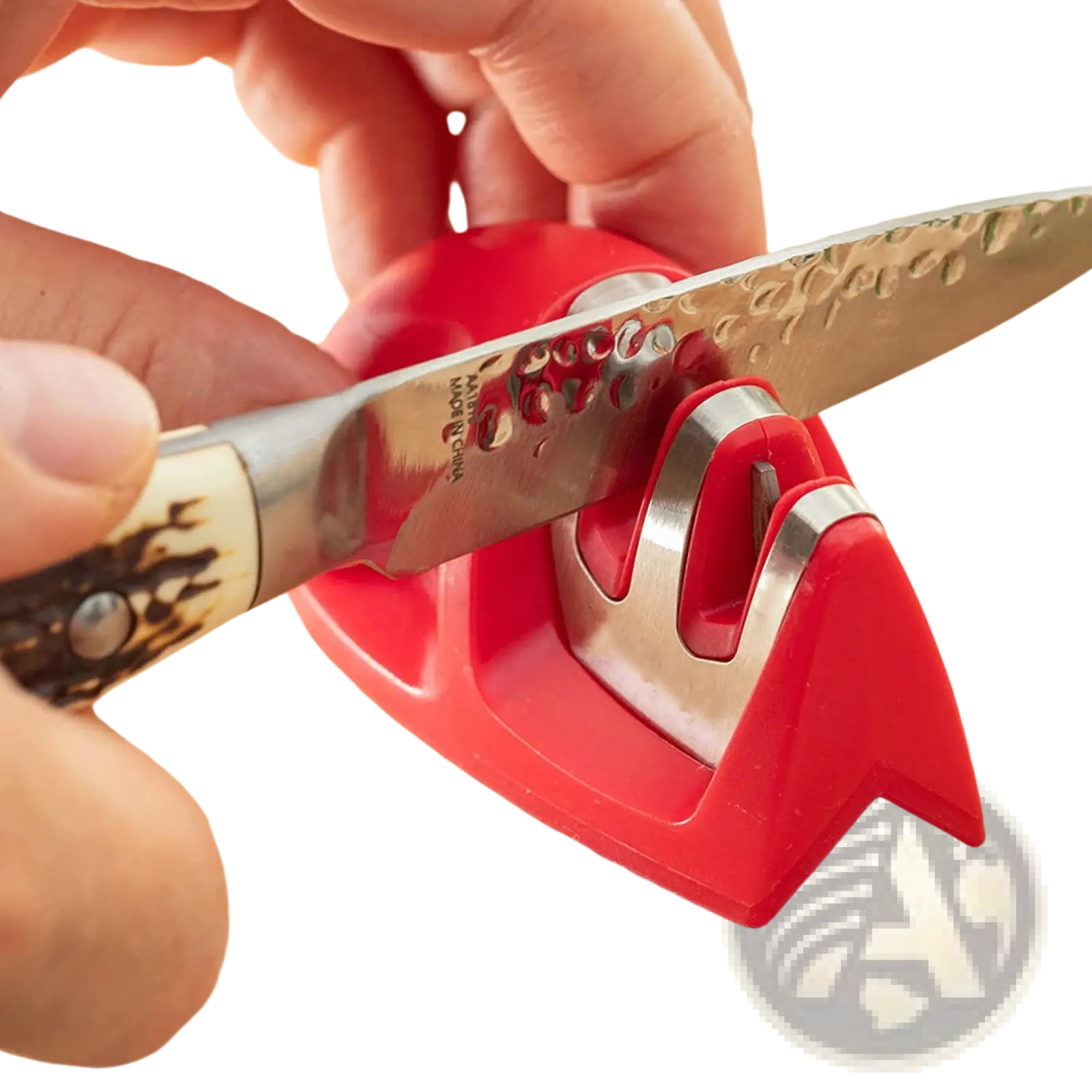 Red plastic and stainless steel portable 3 slot mouse knife sharpener with textured blade being sharpened