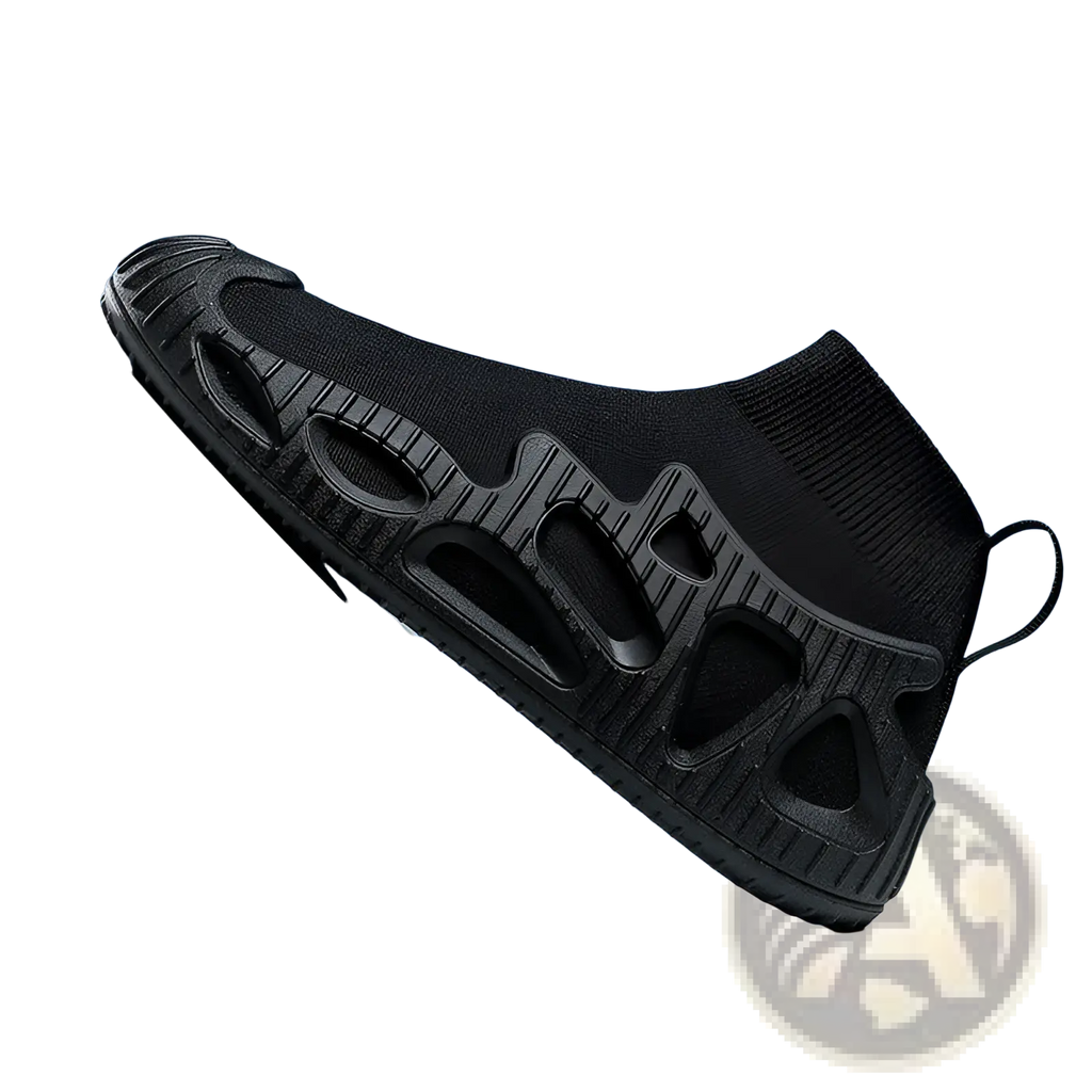 Black knit sock sneaker with textured molded rubber sole featuring geometric cutouts and integrated pull tab