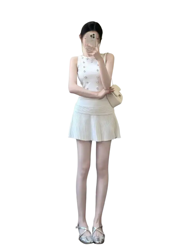 A white sleeveless knit tank top and pleated mini skirt set with buttoned front closure and length 40cm size information