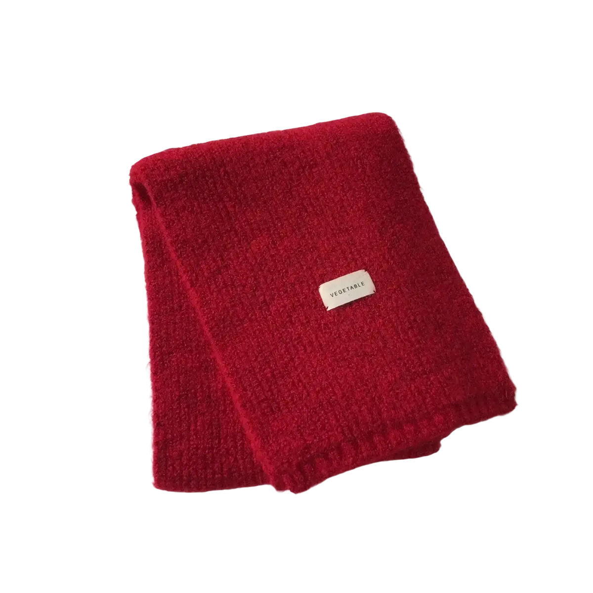 A plush deep red knitted cashmere winter scarf with textured weave and a small white vegetable label near the corner