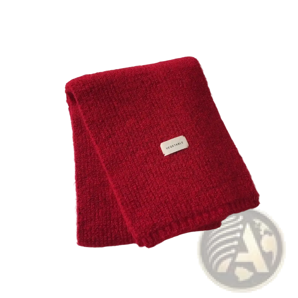 A vibrant red knitted cashmere winter scarf for women with a soft textured surface and a small white vegetable label