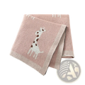 Knitted cotton giraffe baby blanket in soft pink featuring a white and brown giraffe design with textured weave