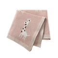 Knitted cotton giraffe baby blanket in soft pink featuring a white and brown giraffe design with textured weave