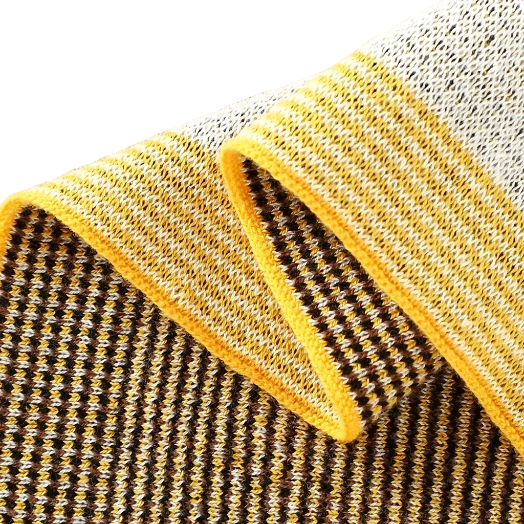 Knitted cotton giraffe baby blanket featuring a soft scarf with a vibrant yellow border and brown cream houndstooth pattern