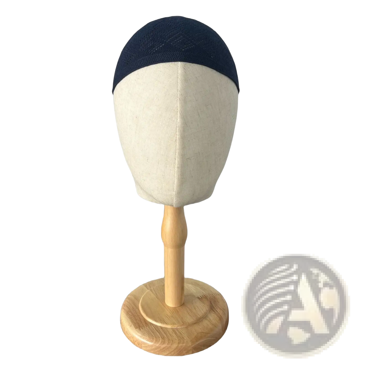 Navy blue knitted kufi beanie prayer cap displayed on a wooden mannequin head for Islamic use