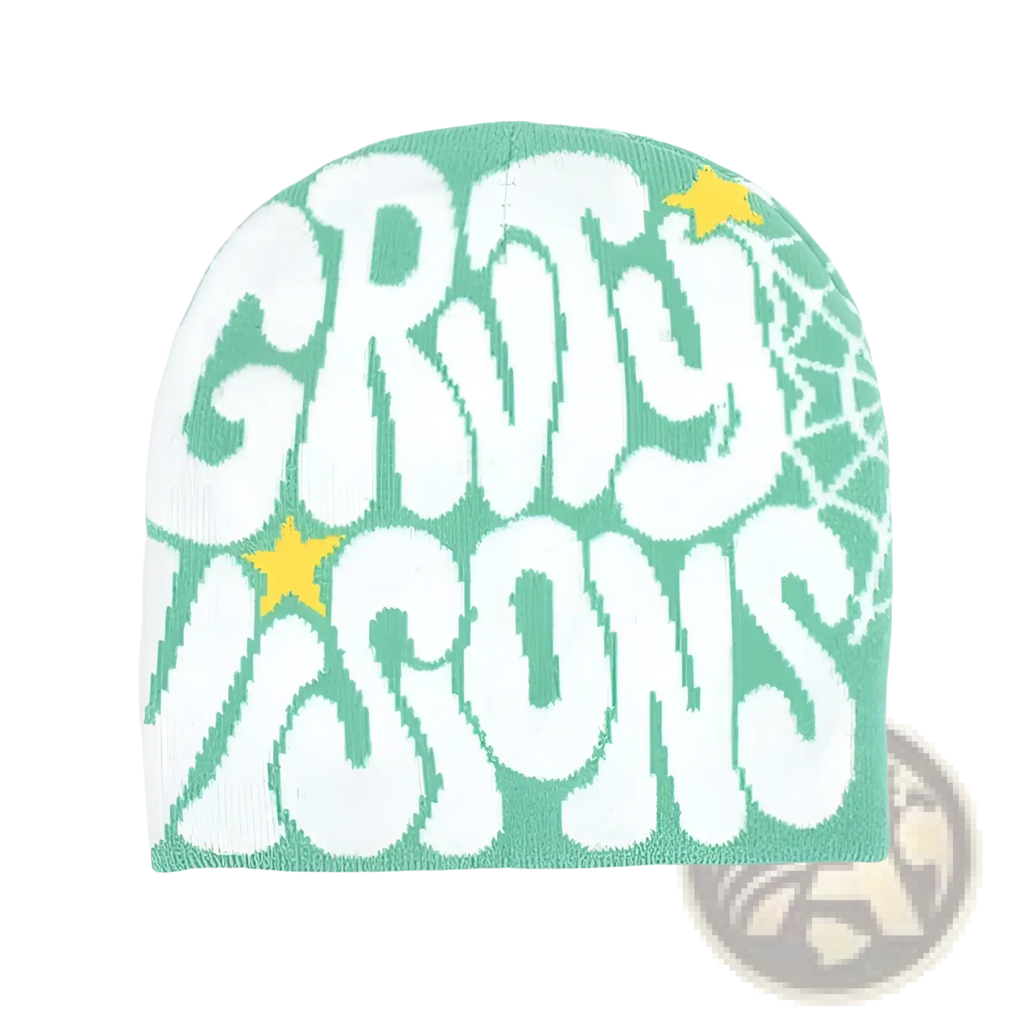 A mint green knitted letter jacquard beanie hat featuring bold white gruty icons lettering, yellow stars, and spiderweb pattern