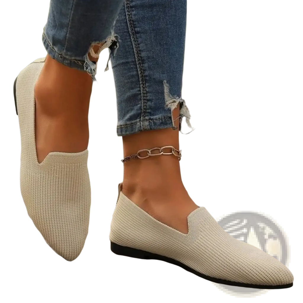 Beige knitted slip-on flats with a pointed toe and black rubber sole designed for comfortable casual wear