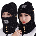 Black knit winter balaclava with face mask and gold-tone buttons featuring speckled texture and subciet patch