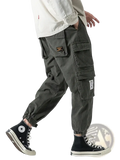 Dark olive green Korean cargo jogger pants for men featuring multiple pockets and fabric patches for casual wear