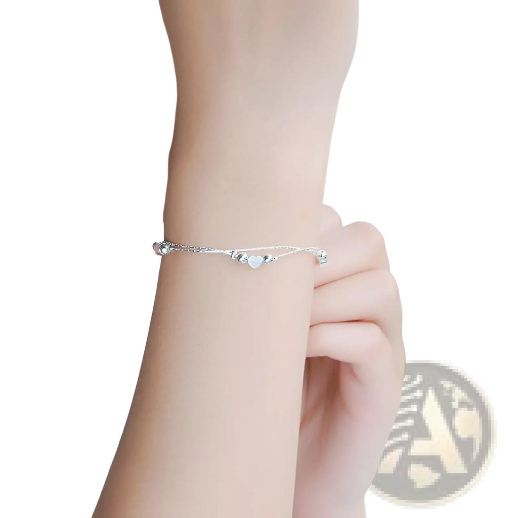 A delicate korean double layer silver heart bead bracelet with fine chain and small spherical silver beads