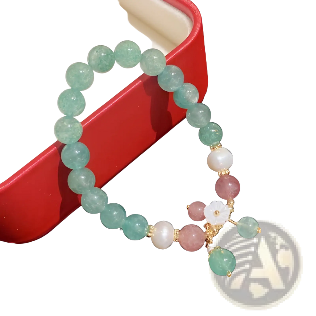 A delicate Korean floral green strawberry crystal beaded bracelet with translucent pink gemstones and gold accents