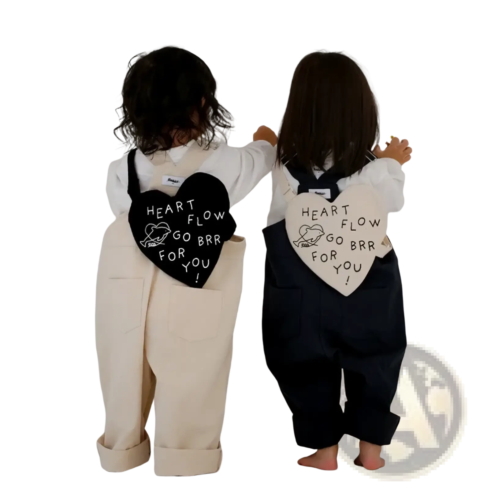 Back view of two children wearing black and white Korean kids heart crossbody bags with heart-shaped patches and playful text