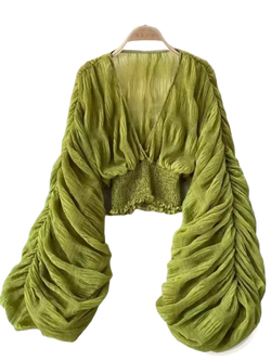 A vibrant olive green Korean v-neck lantern sleeve chiffon blouse with ruched long sleeves and a smocked waistband