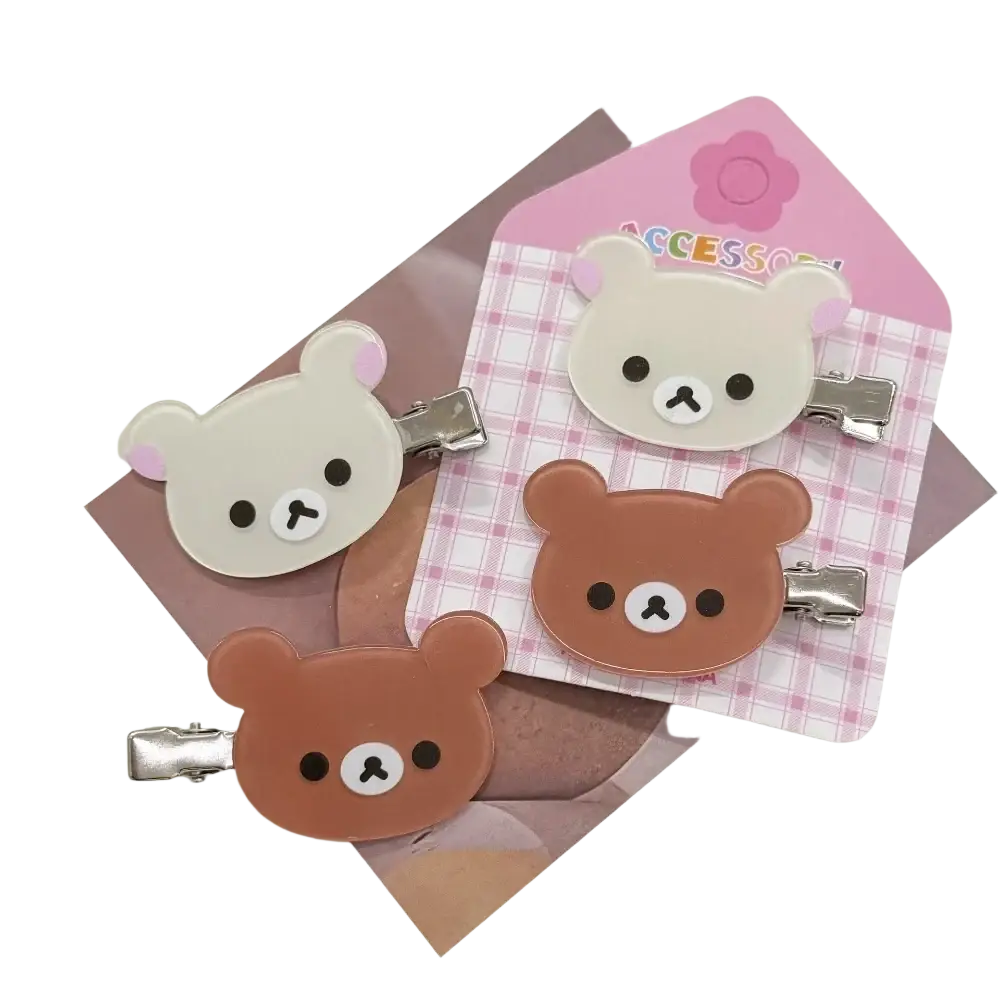 Cute pastel korilakkuma hair clips featuring glossy rilakkuma plastic faces and silver metal clasps for anime styling