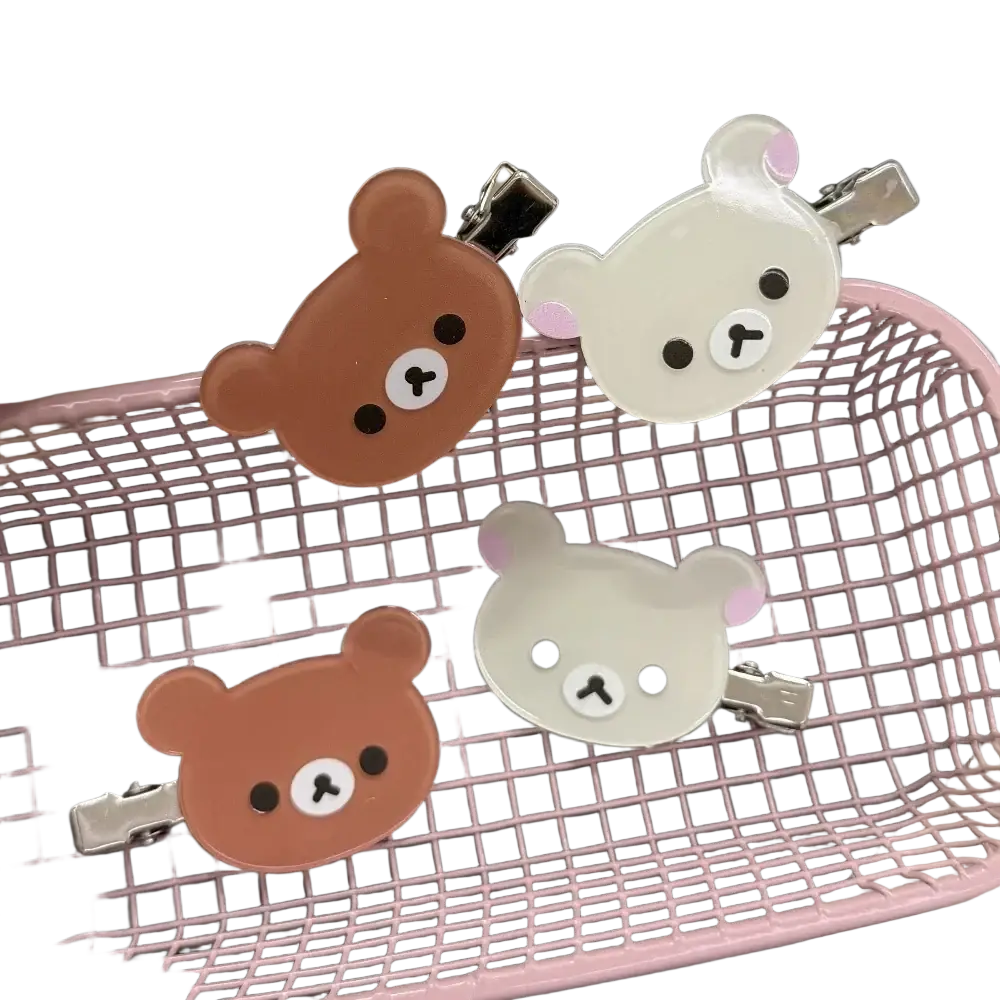 Korilakkuma hair clips featuring brown and white glossy bear faces with pink ears and metallic clamps for anime fans