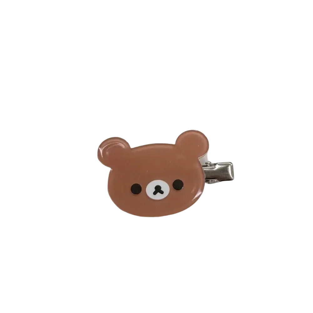 A glossy brown rilakkuma korilakkuma hair clip with black eyes white nose and silver metal clasp for hair clips anime use