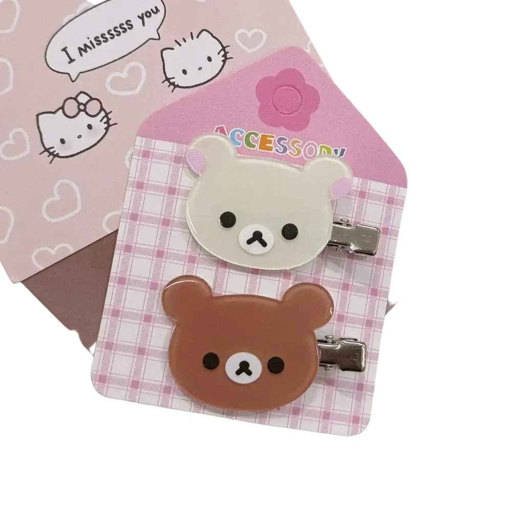Two cute rilakkuma korilakkuma hair clips in cream and brown with glossy plastic anime bear faces and black eyes
