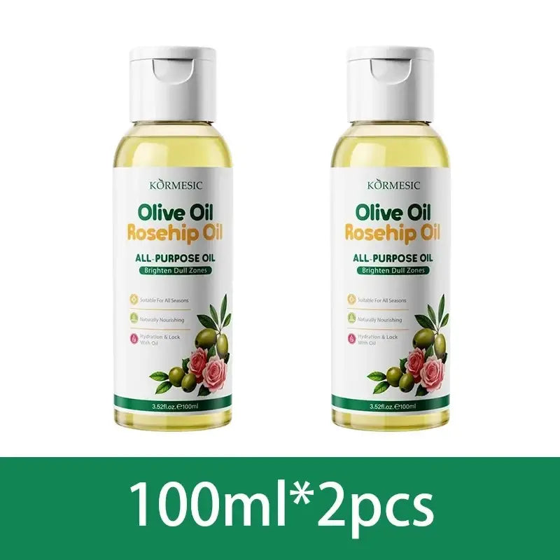 Two 100ml bottles of Kormesic olive rosehip body massage oil with white caps and labels showing green olives and pink roses