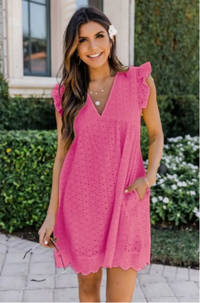 A vibrant pink lace jacquard v neck eyelet beach dress with ruffled cap sleeves scalloped hem and pockets