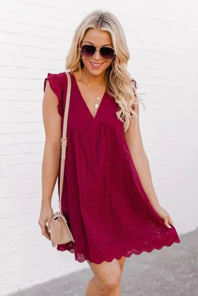 A flowing maroon lace jacquard sleeveless v neck eyelet beach dress with scalloped hem and pockets
