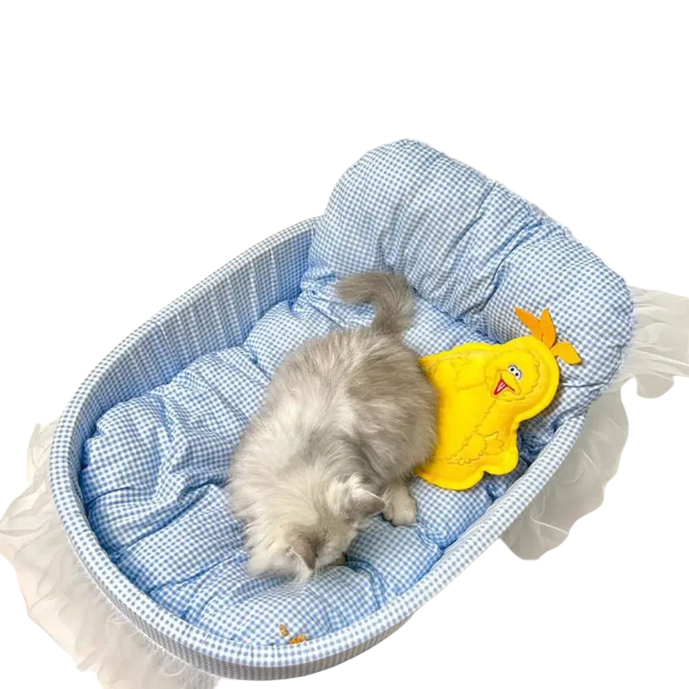 Blue and white checkered plush cat sofa bed with lace edge featuring a yellow chick toy inside oval design