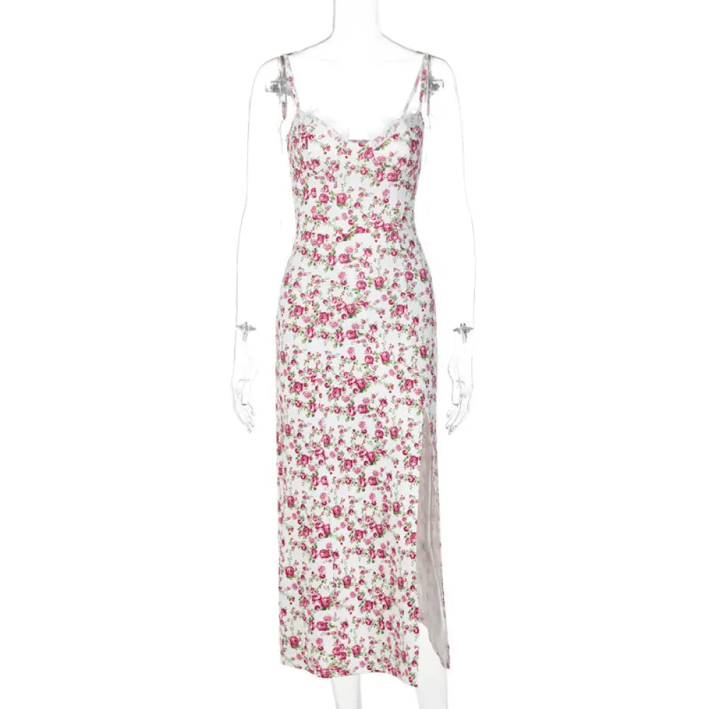 A delicate white satin midi dress with vibrant pink floral print thin spaghetti straps and a side slit