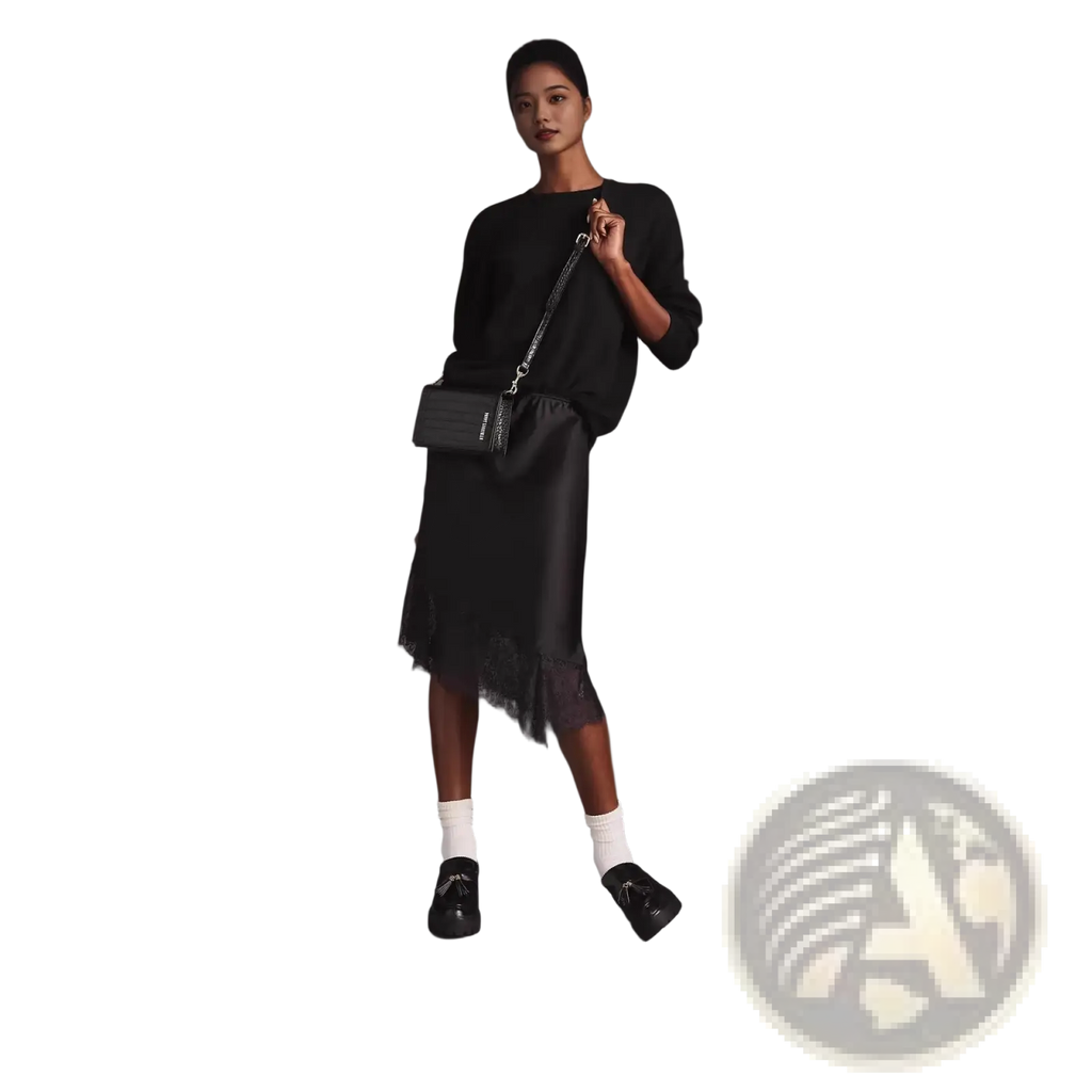 Black quilted crossbody bag with silver chain strap paired with lace satin midi skirt in elegant styling