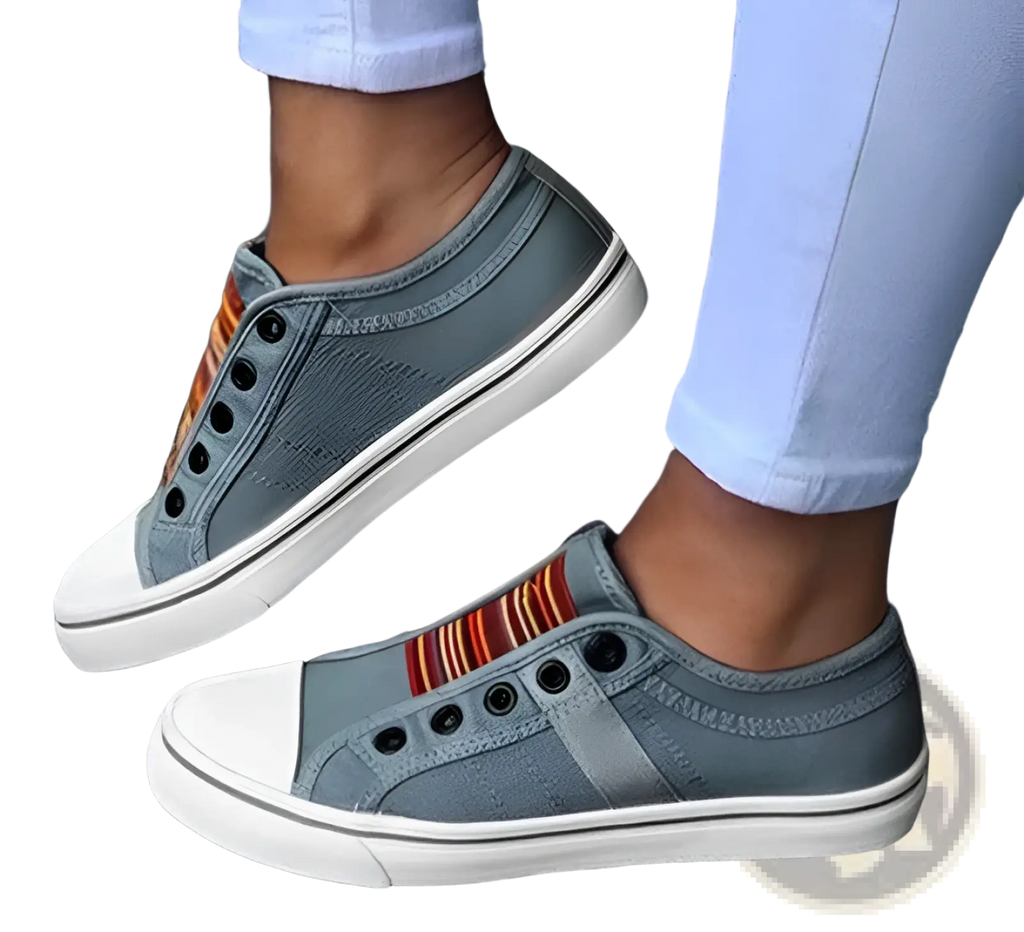 Gray laceless canvas sneakers with white rubber soles and colorful striped fabric detail on the side