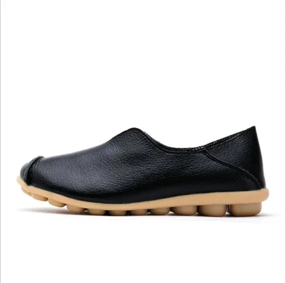 Black leather premium genuine slip on flat shoe with tan segmented rubber sole for comfortable wear