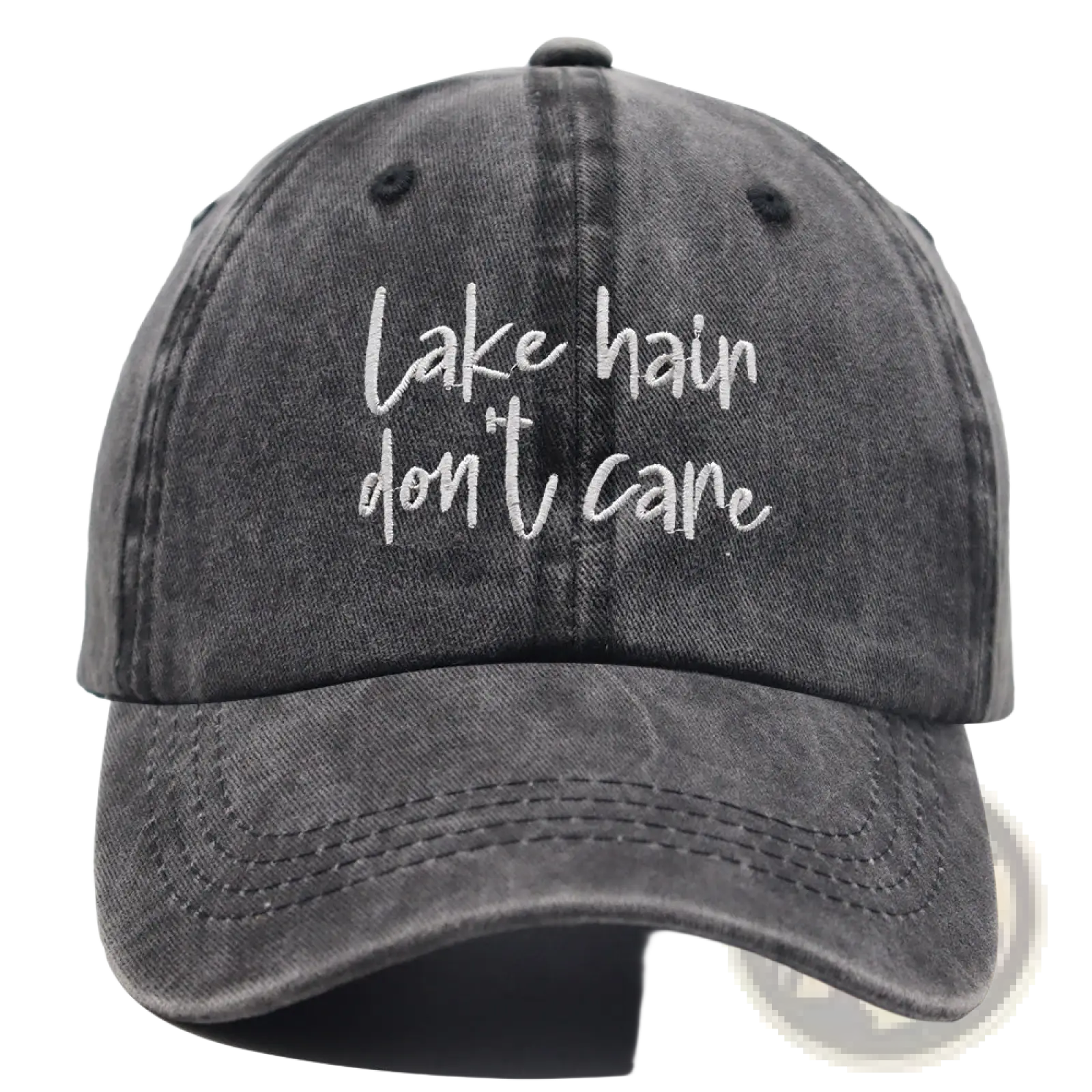 A faded gray denim baseball cap with white cursive embroidery lake hair dont care from the lake hair distressed baseball cap set