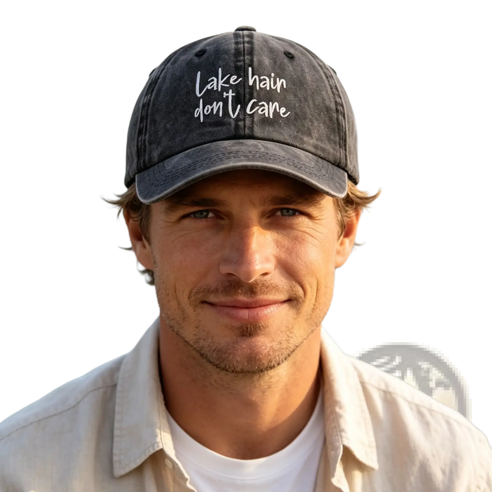 A dark gray distressed baseball cap with white embroidered lake hair dont care text in the lake hair distressed cap set
