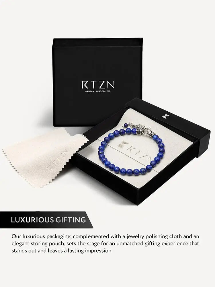 A sleek deep blue aaa lapis lazuli beaded bracelet with silver greek key chain clasp in black rtzn gift box