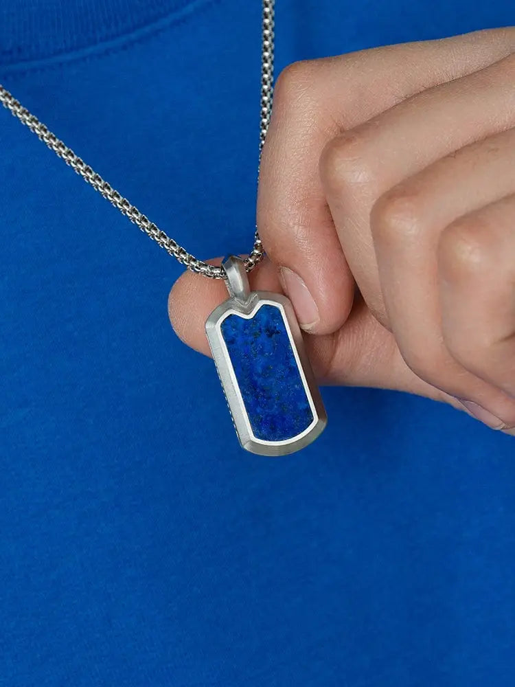 Silver dog tag necklace with vibrant blue lapis lazuli inlay showcasing elegant gemstone detail