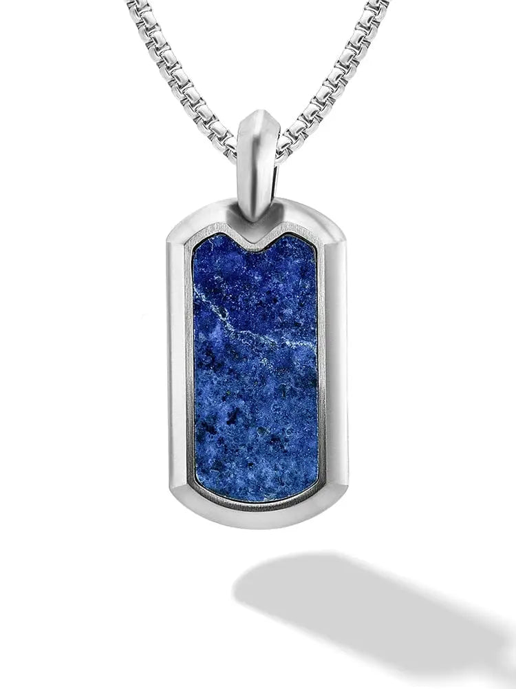 A sleek silver dog tag necklace with a vibrant blue lapis lazuli stone inset on a matching box chain