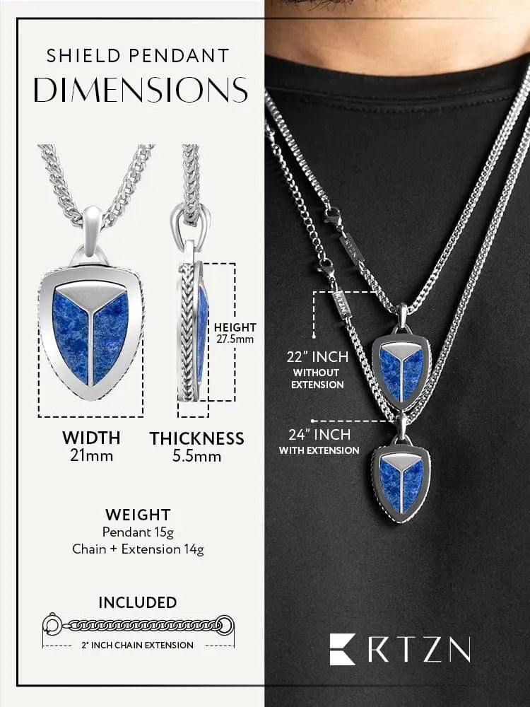 Silver shield-shaped lapis lazuli pendant with vibrant blue inlay in 316l stainless steel and sleek metallic finish