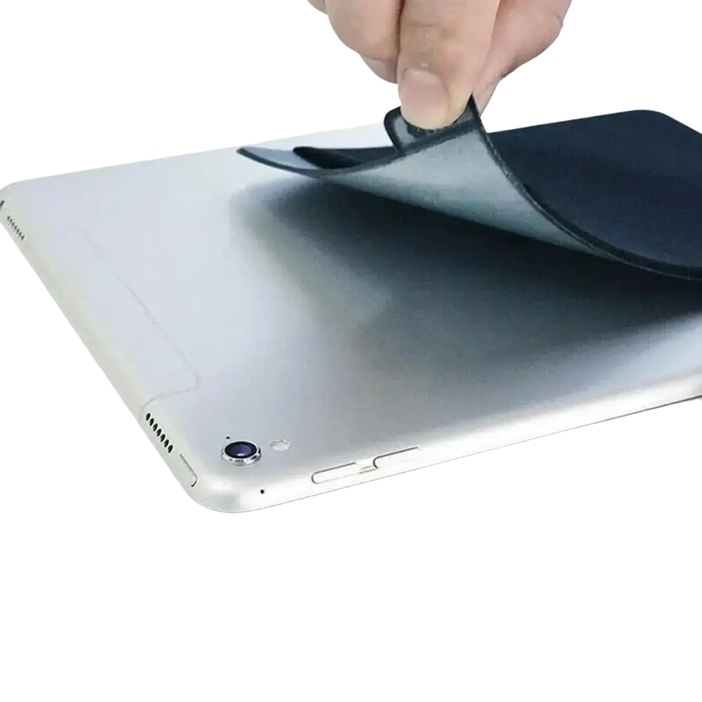 Black flat back sticker on the back side of a silver laptop for a laptop back storage pouch for mouse and accessories
