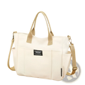 Cream-colored large capacity canvas commuter tote with beige woven leather straps and black canvas bag label on front