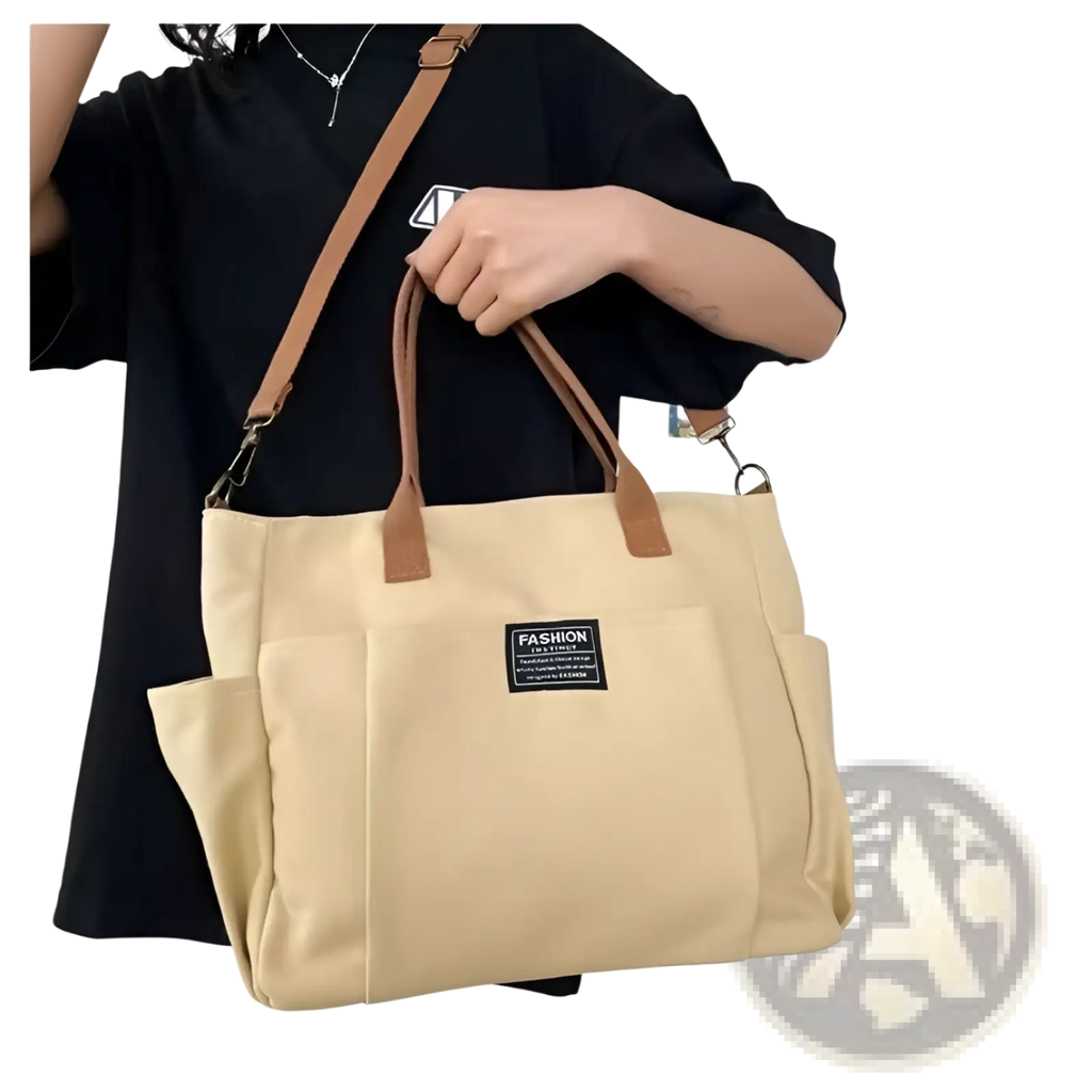Beige large capacity canvas commuter tote with brown leather handles shoulder strap and black fashion patch on front