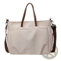 Beige canvas tote bag with large capacity leather handles and shoulder strap for versatile carrying options