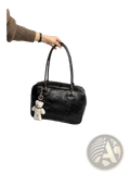 Black glossy leather large capacity shoulder bag with a white plush teddy bear charm hanging from the handle