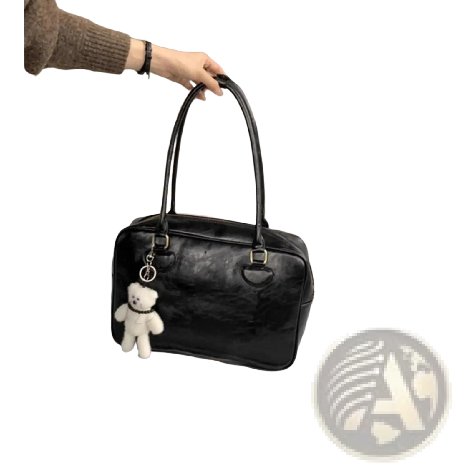 Black patent leather large capacity shoulder bag with white teddy bear charm hanging from the handle