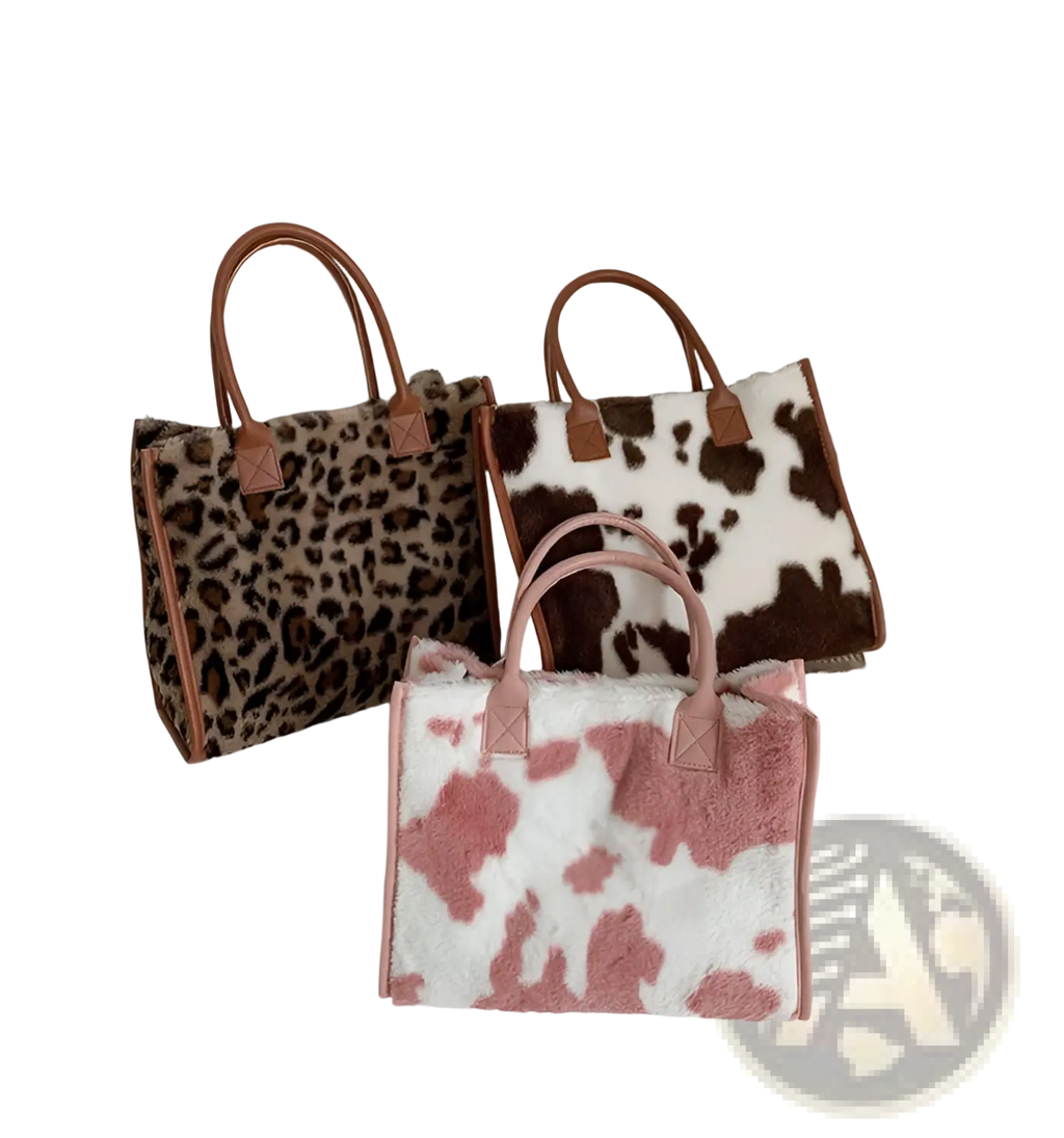 Large capacity plush tote bag with pink and white cow print and brown leather handles for stylish carrying