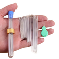 A set of silver metal large eye sewing needles with a green plastic threader in a clear tube with blue cap and gold band