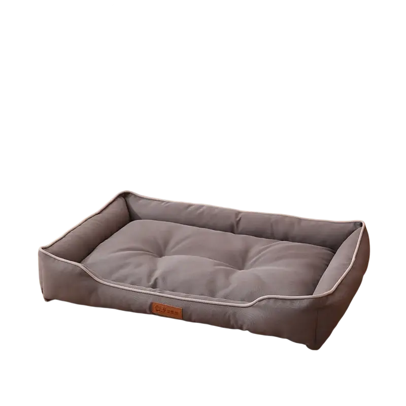 Gray rectangular tufted pet bed with white piping designed as a sofa sleeping bed for dogs