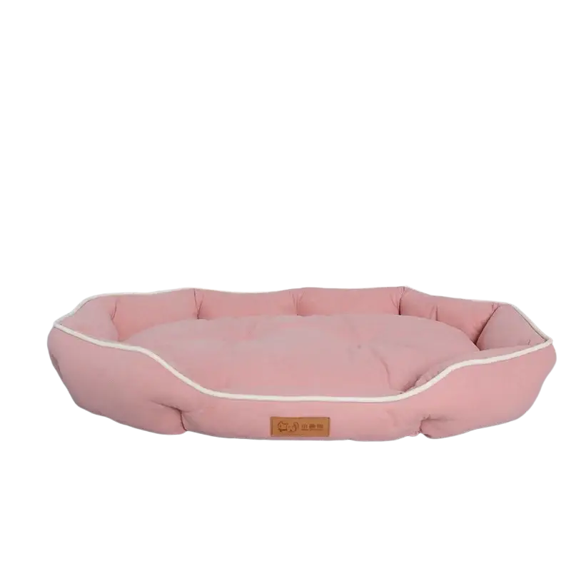 Large pink plush sofa sleeping bed for dogs with cream piping and brown leather-like label in rectangular shape