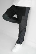 Men’s multi pocket urban techwear tactical joggers in black and dark gray with reinforced panels and utility pockets