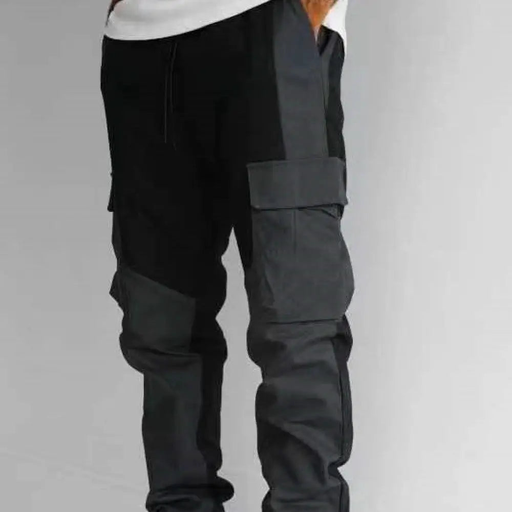 Men’s multi pocket urban techwear tactical joggers in black and dark gray patchwork with multiple large cargo pockets