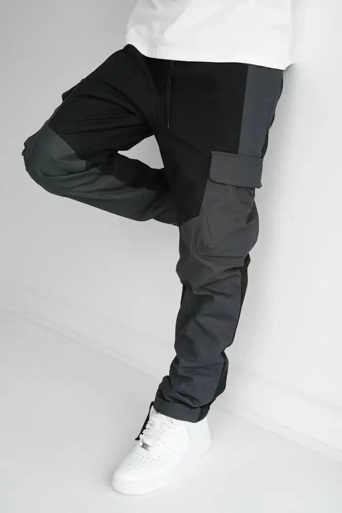 Men’s multi pocket urban techwear tactical joggers in black and dark gray with reinforced panels and utility pockets