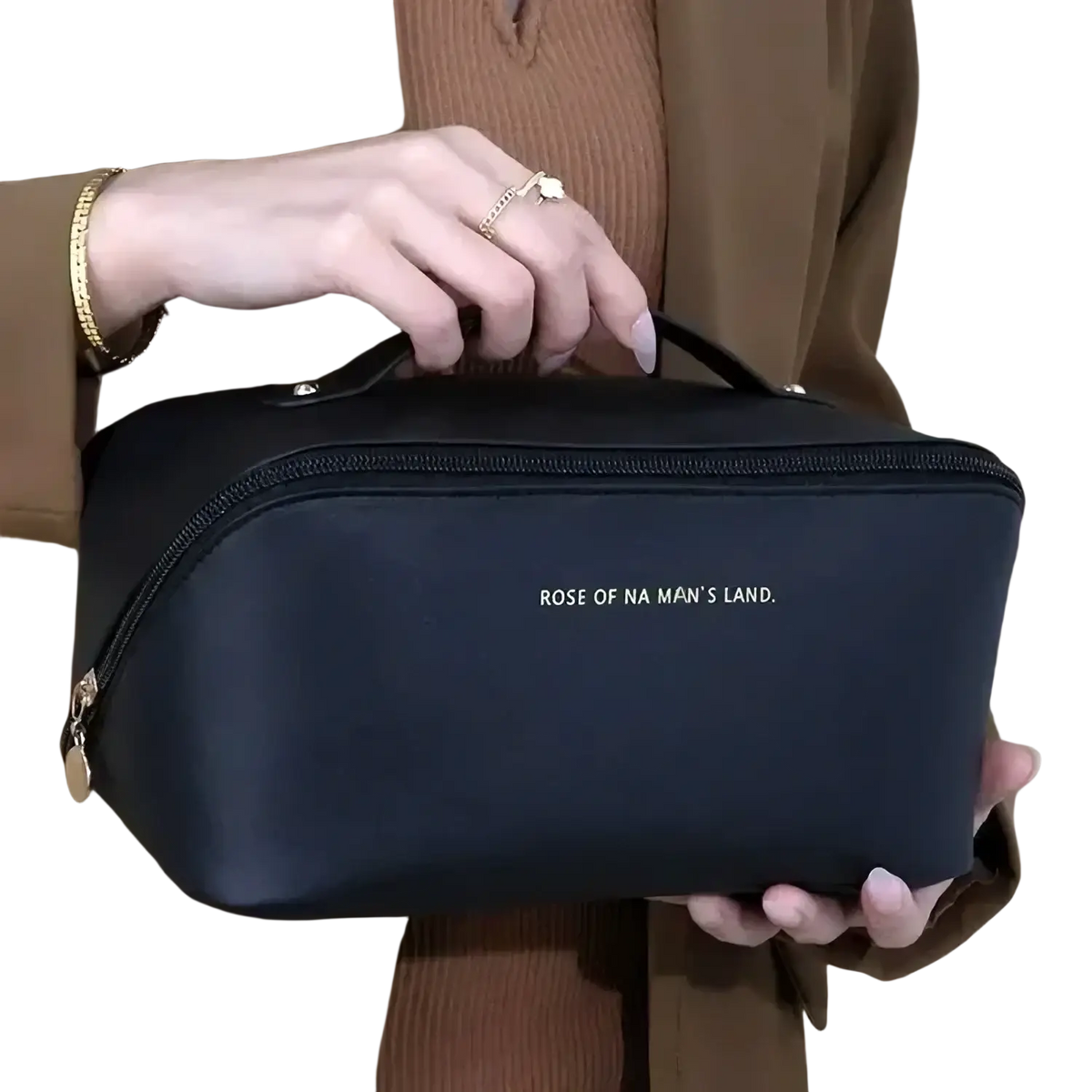 Black rectangular waterproof toiletry organizer with gold zipper handle and rose of na mans land text for travel use